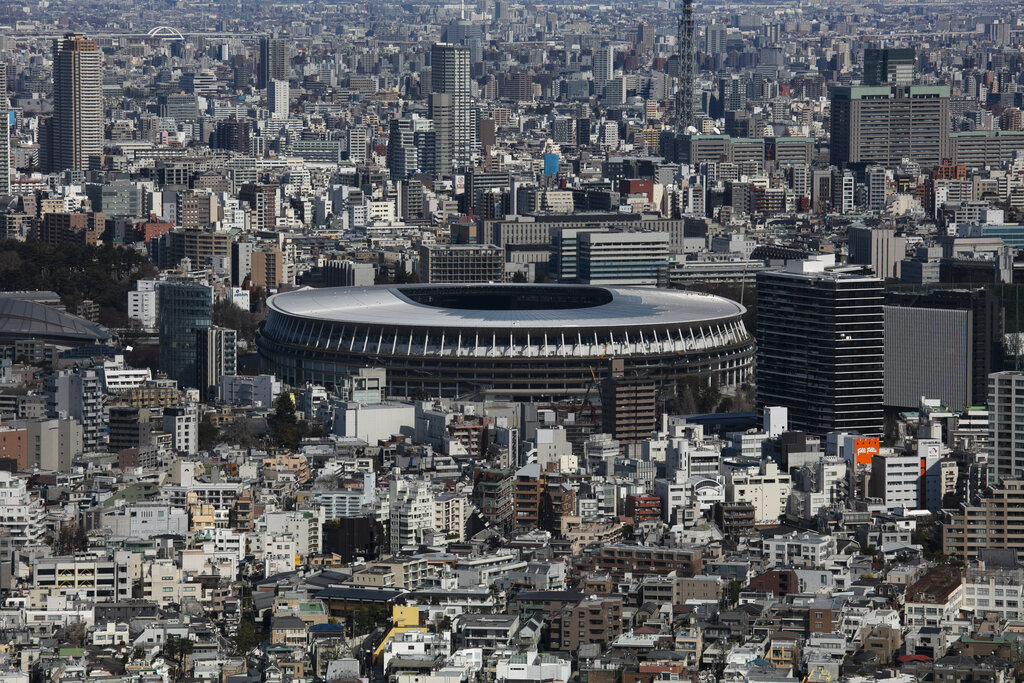 The New National Stadium, a venue for the opening and closing ceremonies at the Tokyo 2020 Olympics, is seen from Shibuya Sky observation deck in Tokyo. The tentacles of cancelling the Tokyo Olympics — or postponing or staging it in empty venues — would reach into every corner of the globe, much like the spreading virus that now imperils the opening ceremony on July 24. (AP Photo/Jae C. Hong, File)