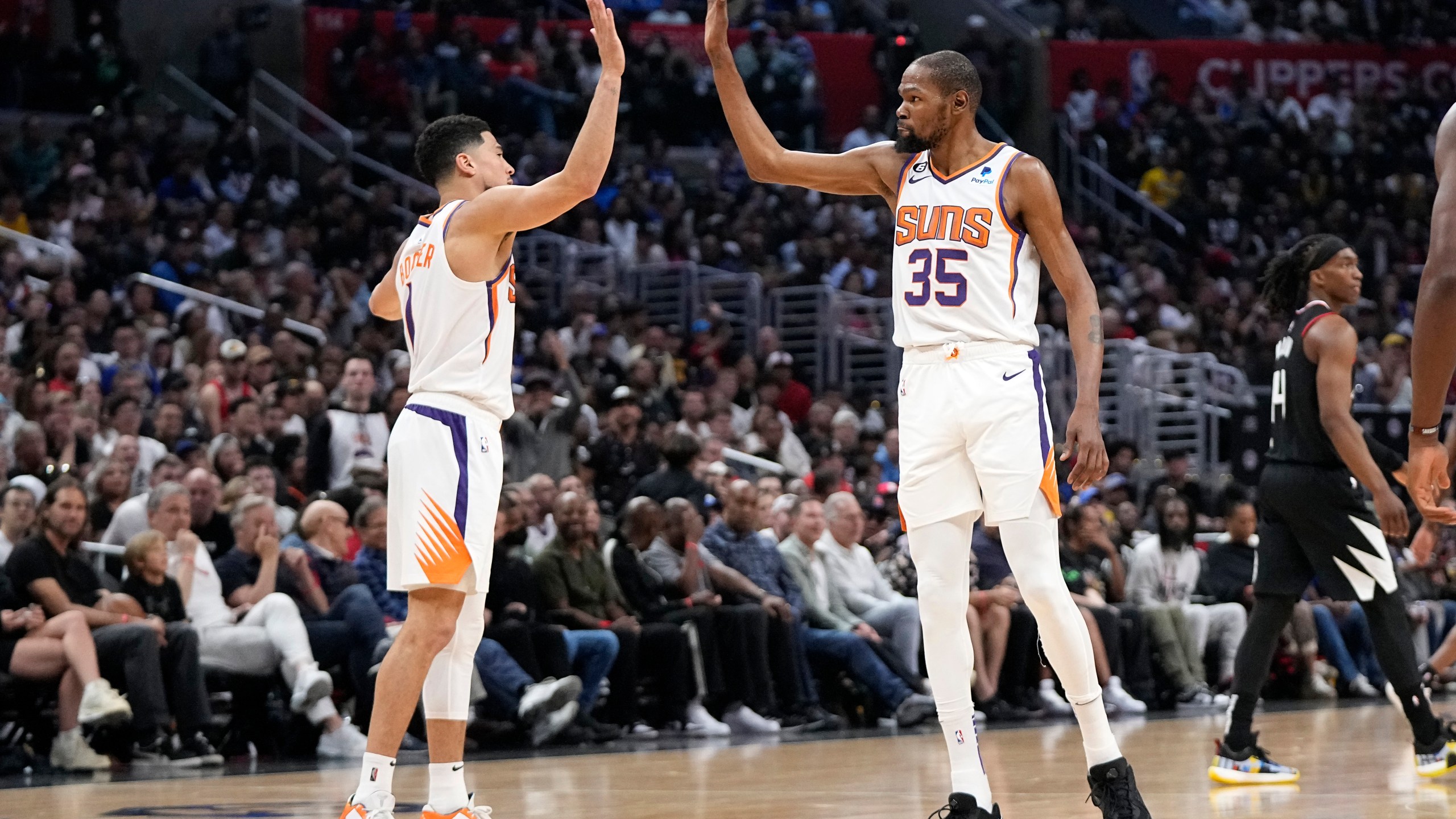 Phoenix Suns guard Devin Booker, left, and forward Kevin Durant congratulate each other during the second half in Game 4 of a first-round NBA basketball playoff series against the Los Angeles Clippers Saturday, April 22, 2023, in Los Angeles. (AP Photo/Mark J. Terrill)