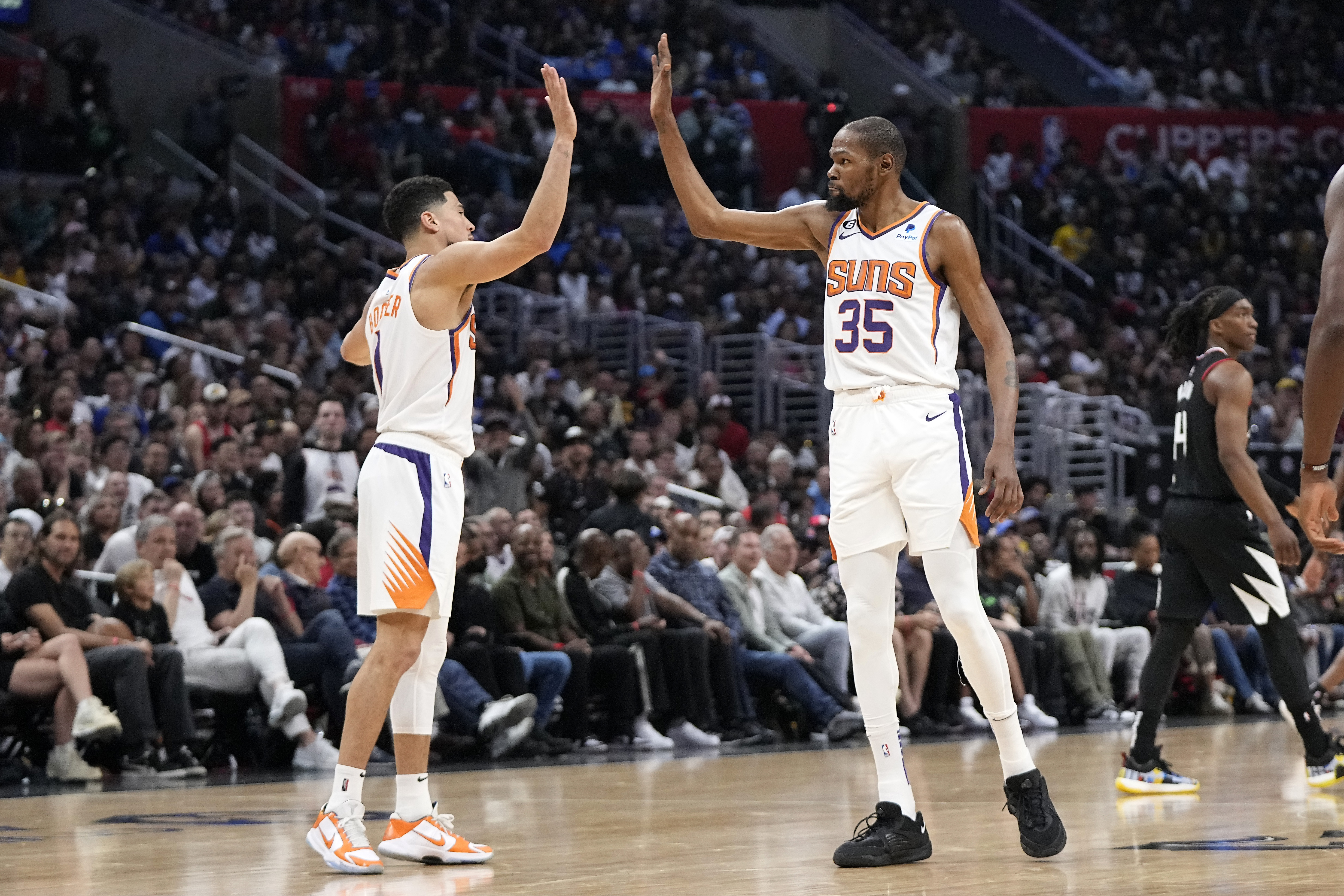 Phoenix Suns guard Devin Booker, left, and forward Kevin Durant congratulate each other during the second half in Game 4 of a first-round NBA basketball playoff series against the Los Angeles Clippers Saturday, April 22, 2023, in Los Angeles. (AP Photo/Mark J. Terrill)