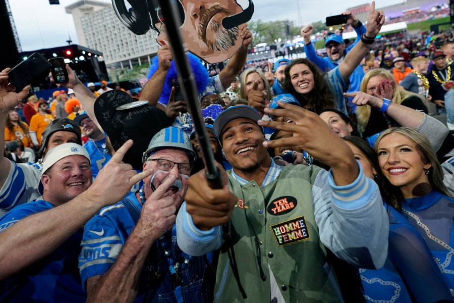 Alabama defensive back Brian Branch takes a selfie with fans after being chosen by the Detroit Lions during the second round of the NFL football draft, Friday, April 28, 2023, in Kansas City, Mo. (AP Photo/Charlie Riedel)