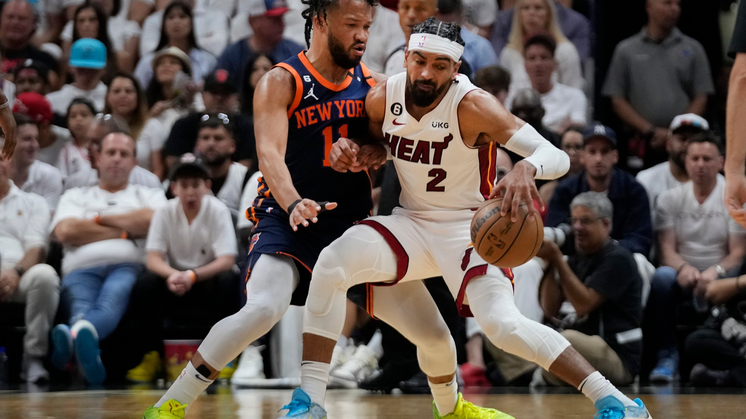 Miami Heat guard Gabe Vincent (2) drives up against New York Knicks guard Jalen Brunson (11) during the first half of Game 3 of an NBA basketball second-round playoff series, Saturday, May 6, 2023, in Miami. (AP Photo/Wilfredo Lee)