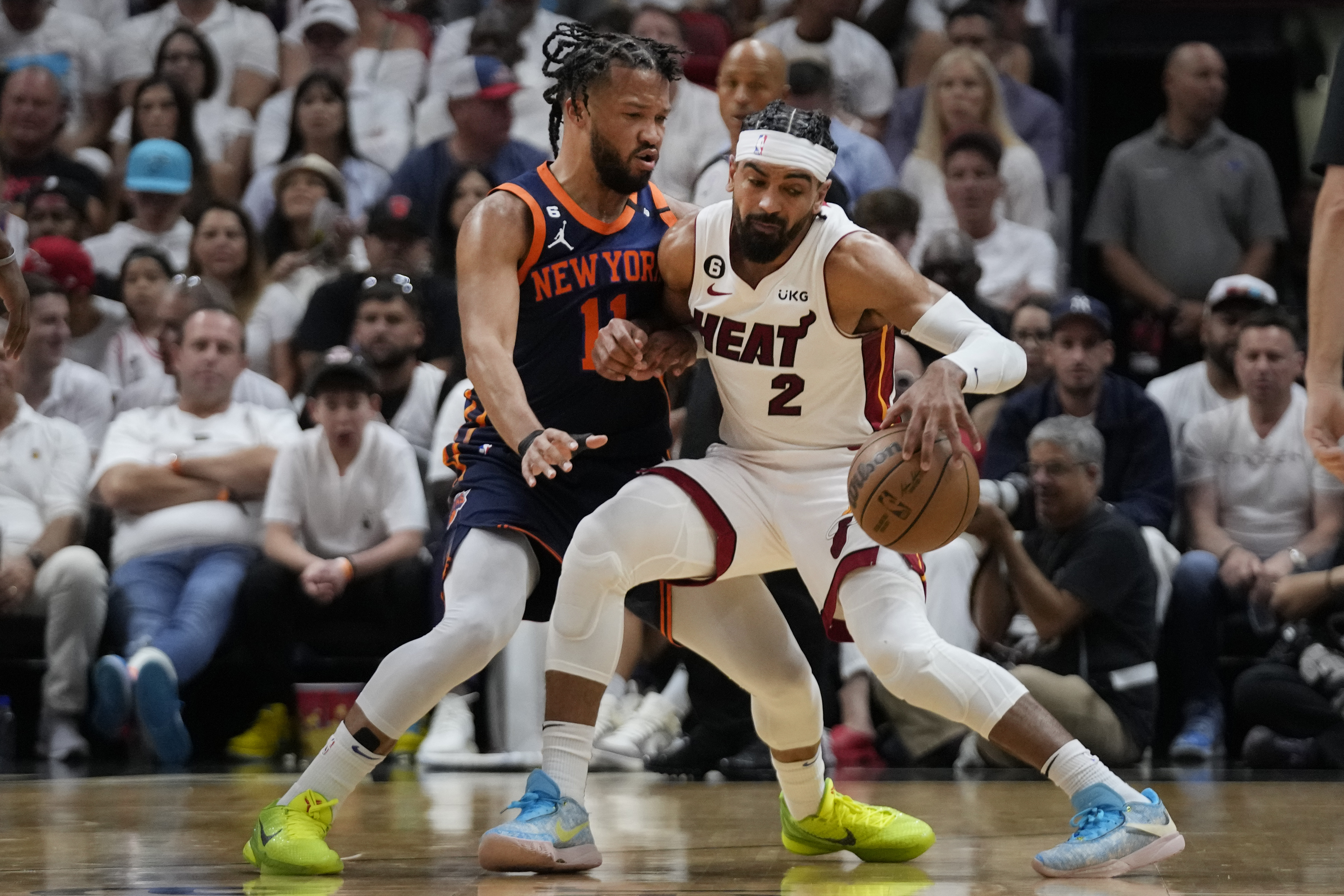 Miami Heat guard Gabe Vincent (2) drives up against New York Knicks guard Jalen Brunson (11) during the first half of Game 3 of an NBA basketball second-round playoff series, Saturday, May 6, 2023, in Miami. (AP Photo/Wilfredo Lee)