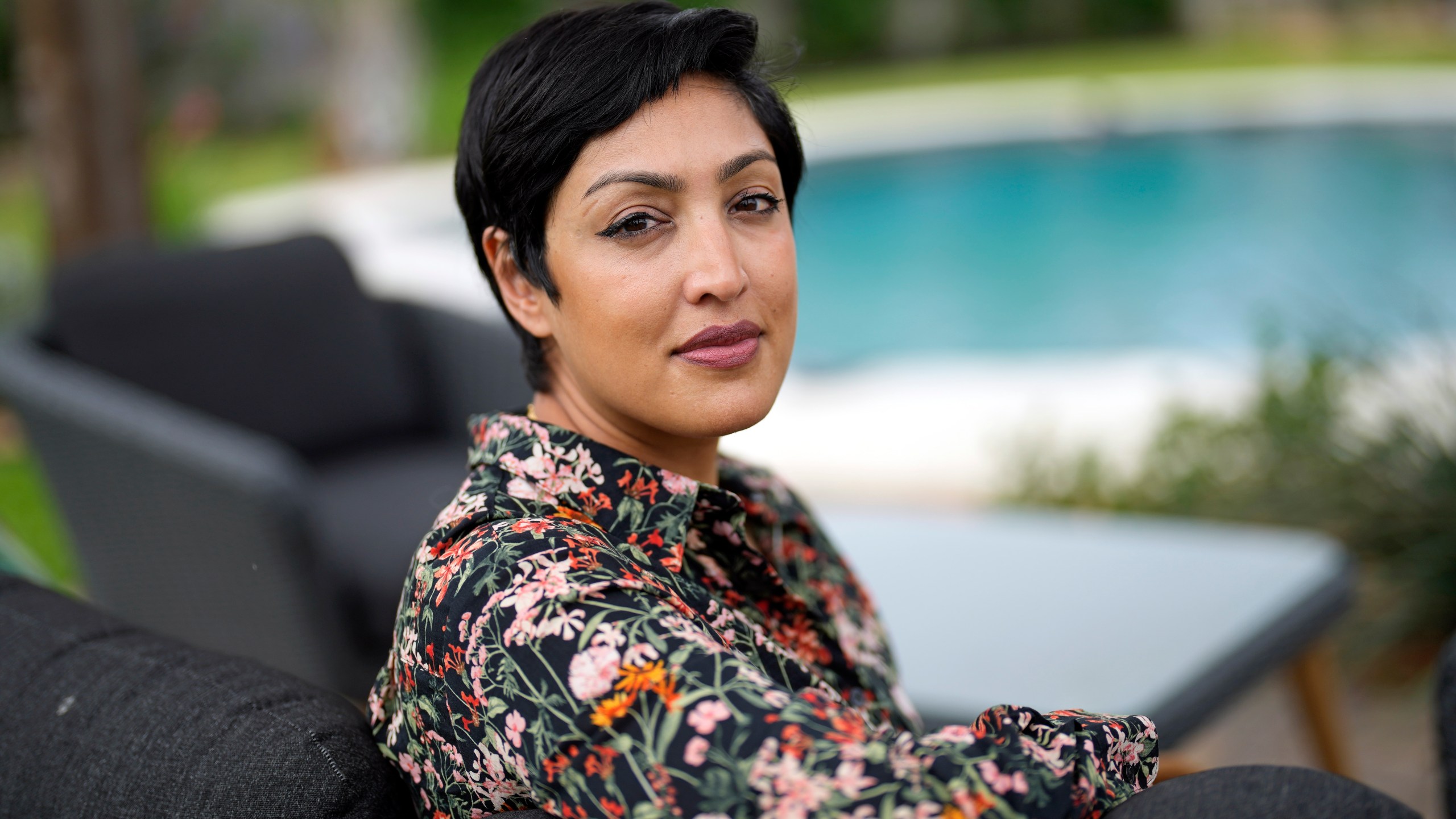 Rumman Chowdhury, co-founder of Humane Intelligence, a nonprofit developing accountable AI systems, poses for a photograph at her home Monday, May 8, 2023, in Katy, Texas. ChatGPT maker OpenAI, and other major AI providers such as Google and Microsoft, are coordinating with the Biden administration to let thousands of hackers take a shot at testing the limits of their technology. Chowdhury is the lead coordinator of the mass hacking event planned for this summer's DEF CON hacker convention in Las Vegas. (AP Photo/David J. Phillip)