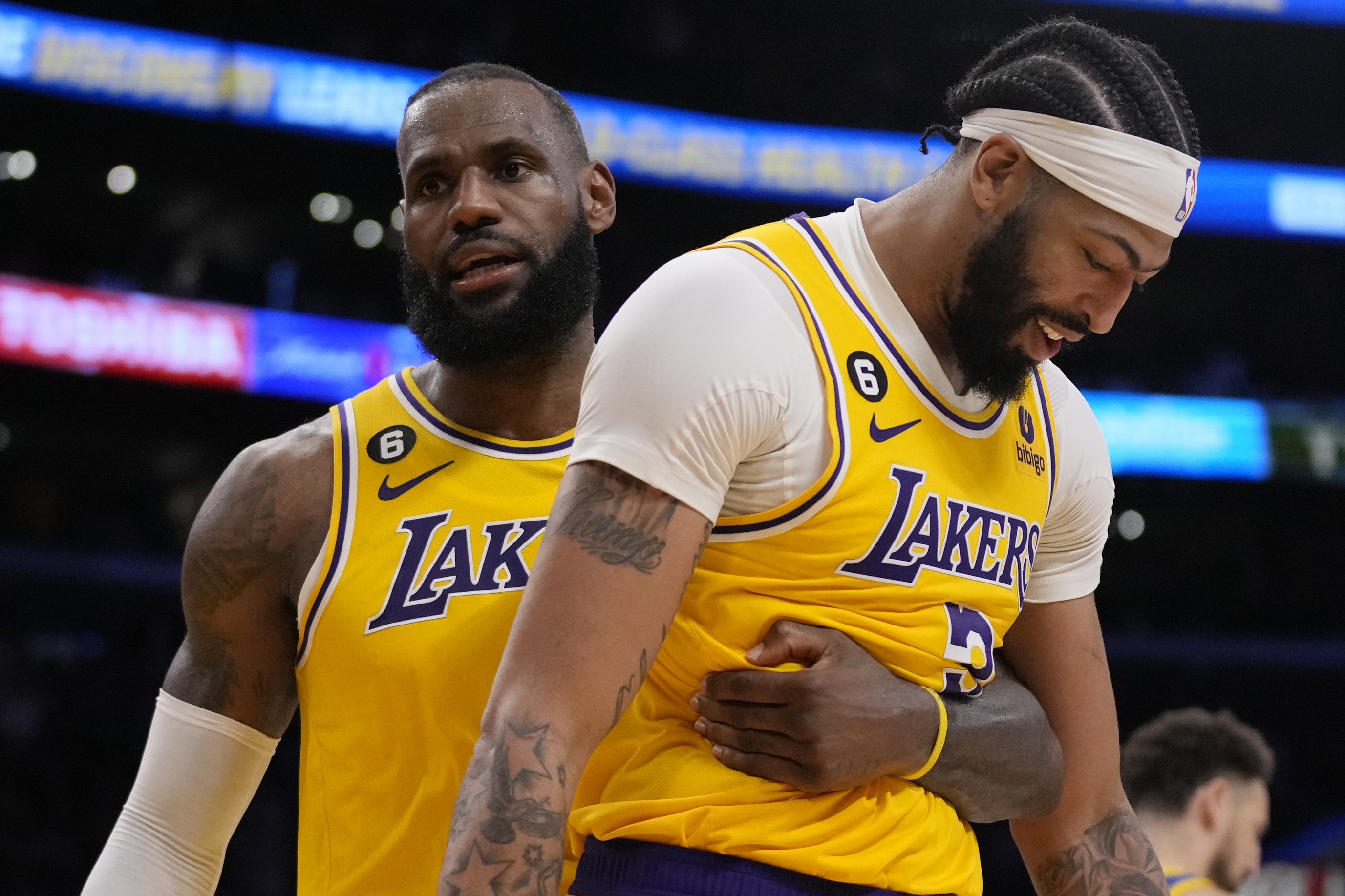 Los Angeles Lakers forward LeBron James, left, hugs forward Anthony Davis during the second half in Game 6 of an NBA basketball Western Conference semifinal series against the Golden State Warriors Friday, May 12, 2023, in Los Angeles. (AP Photo/Ashley Landis)
