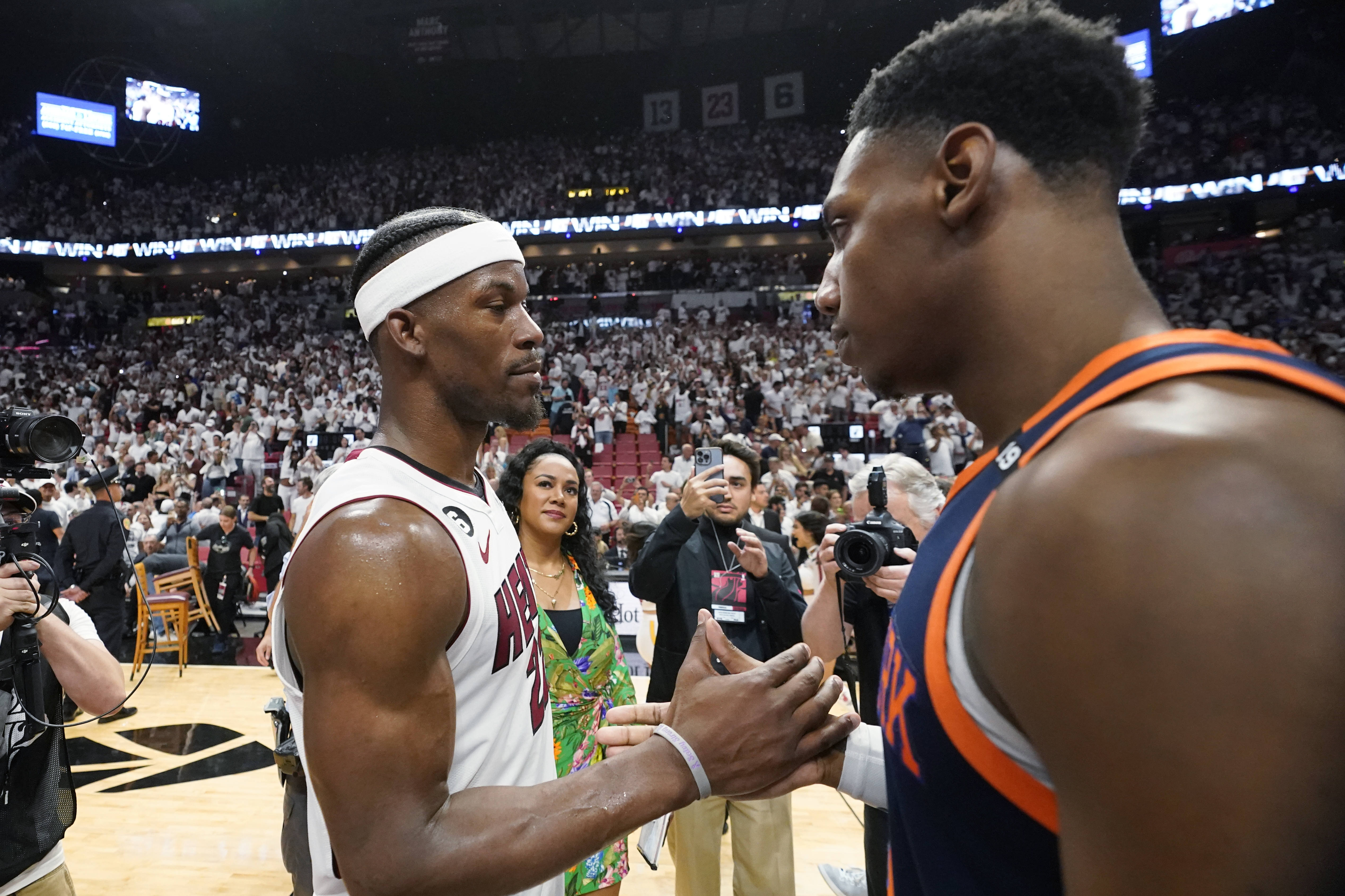 Miami Heat forward Jimmy Butler, left, and New York Knicks guard RJ Barrett congratulate each other after the Heat beat the Knicks 96-92 during Game 6 of an NBA basketball second-round playoff series, Friday, May 12, 2023, in Miami. (AP Photo/Wilfredo Lee)