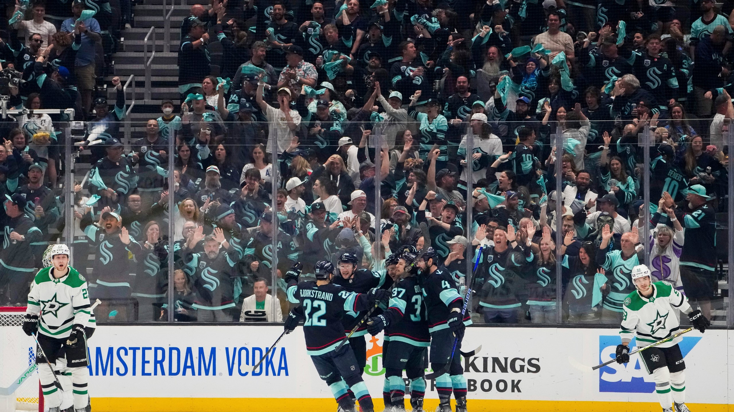 The Seattle Kraken celebrate a goal by right wing Eeli Tolvanen as Dallas Stars defenseman Esa Lindell, left, and center Wyatt Johnston (53) skate away during the second period of Game 6 of an NHL hockey Stanley Cup second-round playoff series Saturday, May 13, 2023, in Seattle. (AP Photo/Lindsey Wasson)