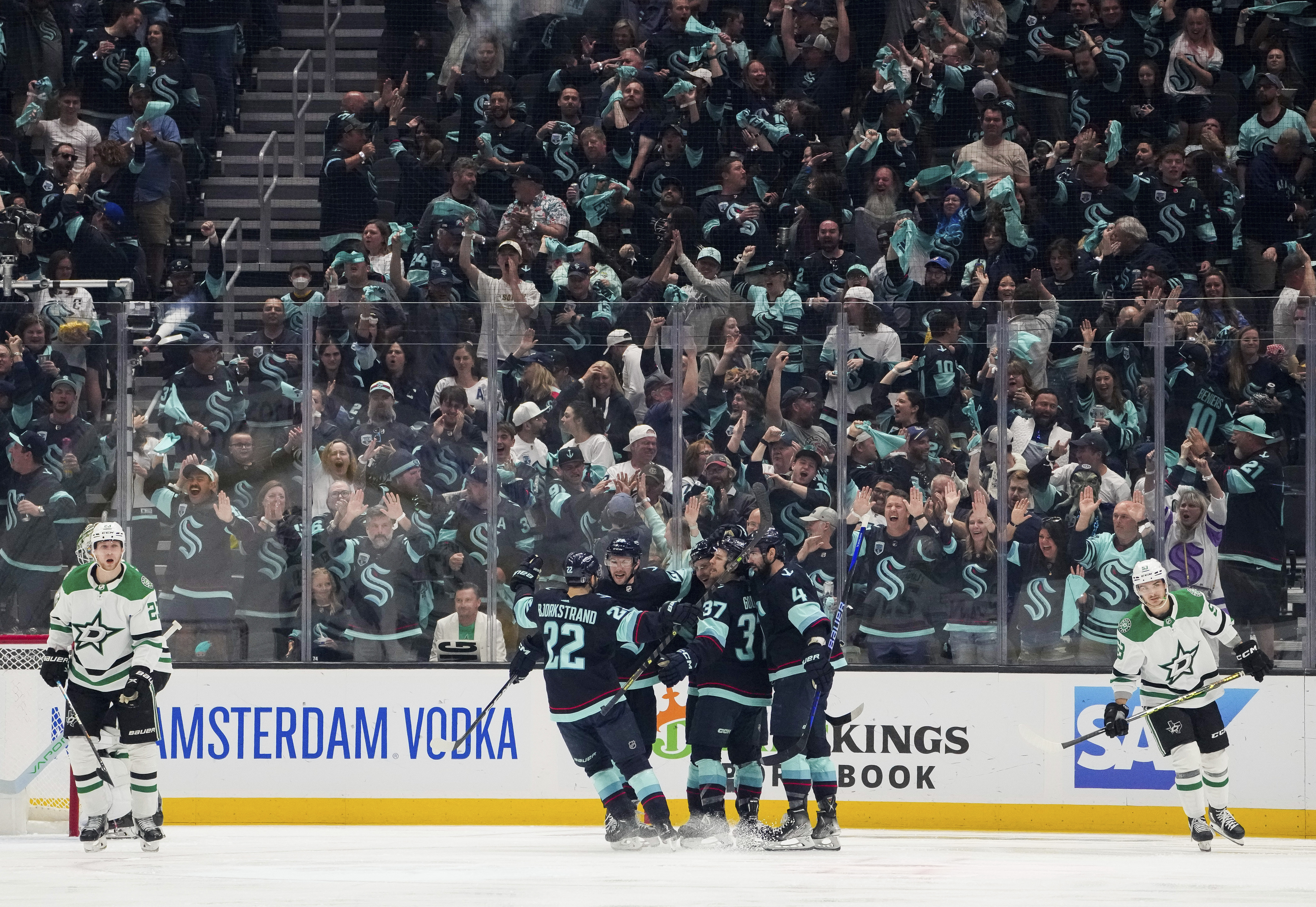 The Seattle Kraken celebrate a goal by right wing Eeli Tolvanen as Dallas Stars defenseman Esa Lindell, left, and center Wyatt Johnston (53) skate away during the second period of Game 6 of an NHL hockey Stanley Cup second-round playoff series Saturday, May 13, 2023, in Seattle. (AP Photo/Lindsey Wasson)