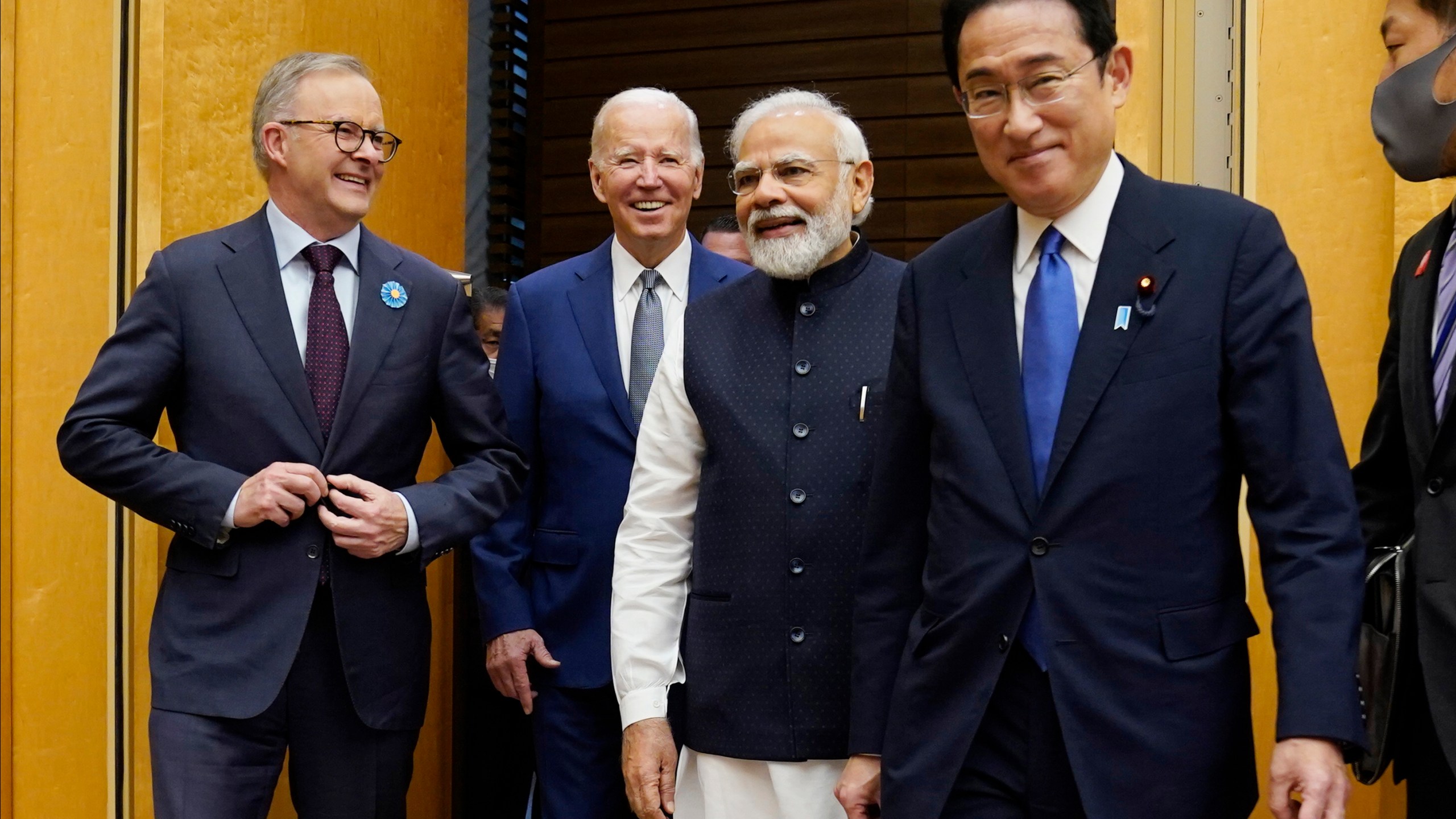 FILE - From left, Australian Prime Minister Anthony Albanese, U.S. President Joe Biden and Indian Prime Minister Narendra Modi are greeted by Japanese Prime Minister Fumio Kishida, right, during their arrival to the Quad leaders summit at Kantei Palace, May 24, 2022, in Tokyo. Biden has an ambitious agenda when he sets off later this week on an eight-day trip to the Indo-Pacific. For part of his trip Biden will travel to Australia for a summit with fellow Quad leaders. (AP Photo/Evan Vucci, File)