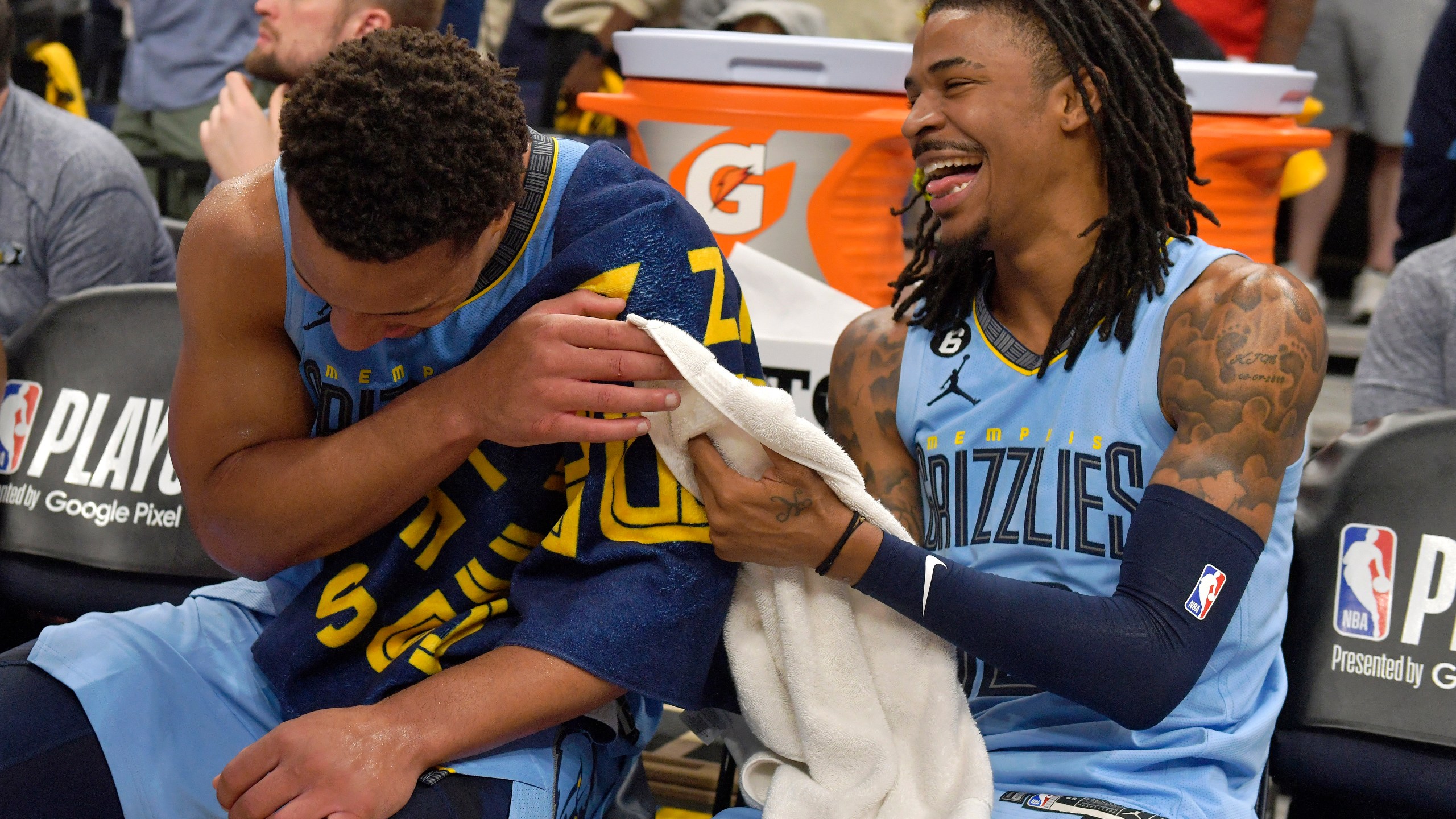 Memphis Grizzlies guards Desmond Bane, left, and Ja Morant (12) laugh on the bench during the second half of Game 5 of the team's first-round NBA basketball playoff series against the Los Angeles Lakers on Wednesday, April 26, 2023, in Memphis, Tenn. (AP Photo/Brandon Dill)