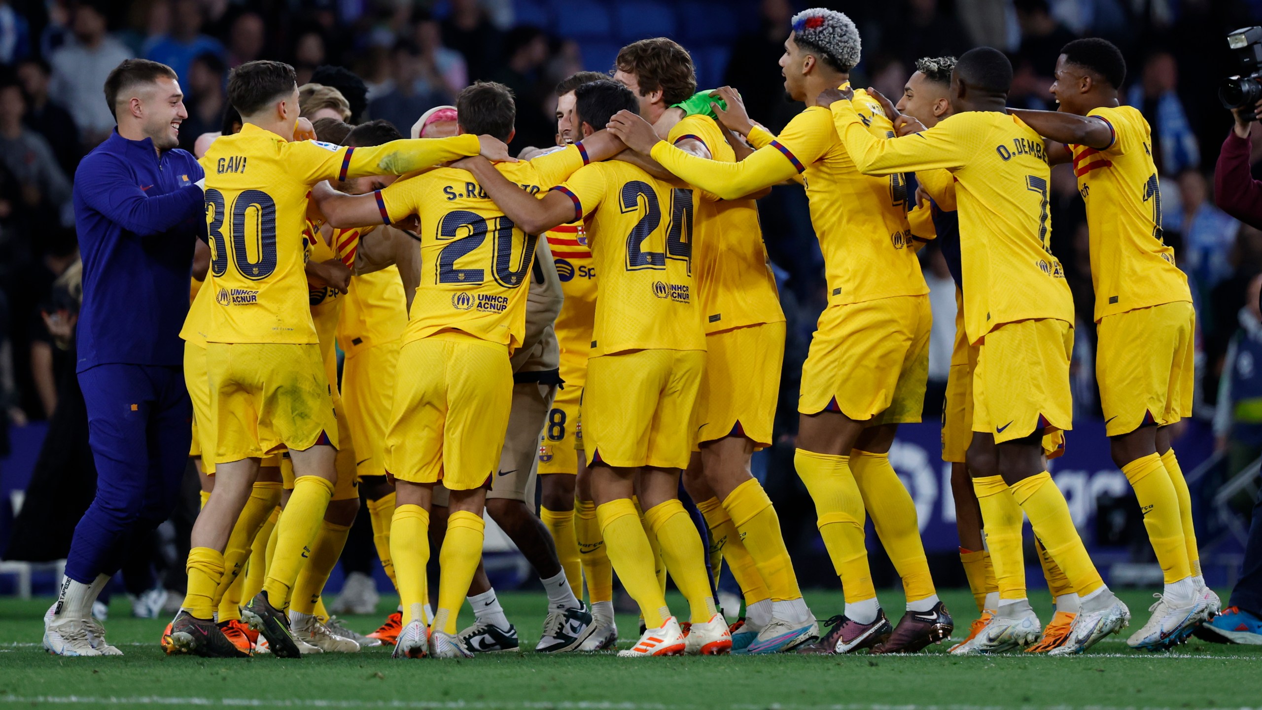 Barcelona players celebrate after the Spanish La Liga soccer match between Espanyol and Barcelona at the RCDE stadium in Barcelona, Sunday, May 14, 2023. (AP Photo/Joan Monfort)