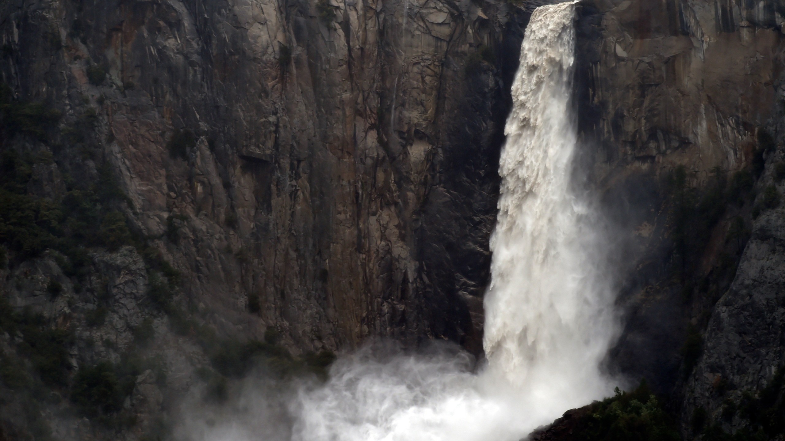 FILE - In this April 7, 2018, file photo, the raging Bridalveil Fall plummets into Yosemite Valley, while closed to the public due to a flooding Merced River, in Yosemite National Park, Calif. Three popular campgrounds at California's Yosemite National Park will be temporarily closed starting Monday, May 15, 2023, due to a forecast of flooding as warming temperatures melt the Sierra Nevada's massive snowpack. Park officials said Sunday that Lower and North Pines Campgrounds and Housekeeping Camp will be shut over fears that waterways could overspill their banks. (Eric Paul Zamora/The Fresno Bee via AP, File)