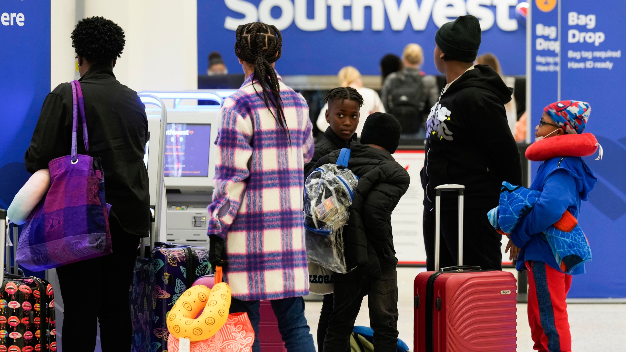 Travelers check in at Southwest Airlines at George Bush Intercontinental Airport, Tuesday, Nov. 21, 2023, in Houston. (Jason Fochtman/Houston Chronicle via AP)