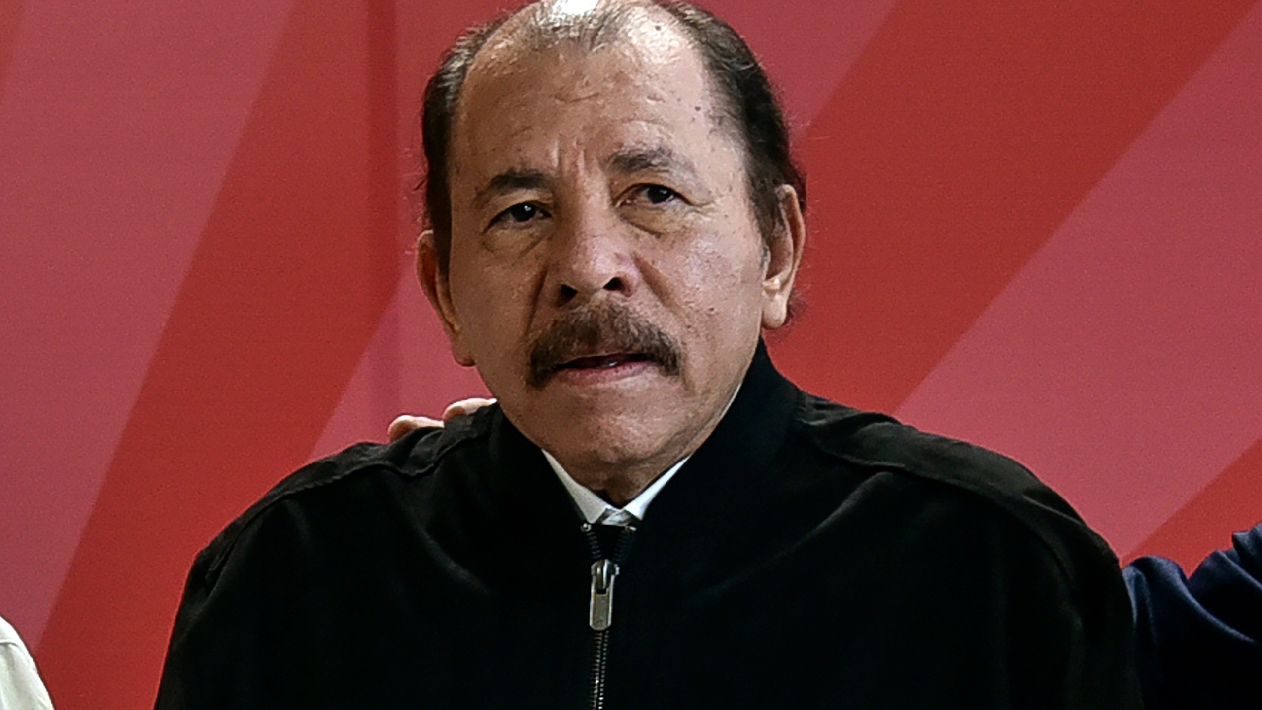 FILE - Nicaragua's President Daniel Ortega poses for a photo during the ALBA Summit at the Palace of the Revolution in Havana, Cuba, Tuesday, Dec. 14, 2021. A new study released Wednesday, Nov. 29, 2023 says that about half of Nicaragua's population of 6.2 million want to leave their homeland because of a mix of economic decline and repression from President Daniel Ortega's government. The study said that 23% considered themselves “very prepared” to emigrate. (Adalberto Roque, Pool Photo via AP, file)