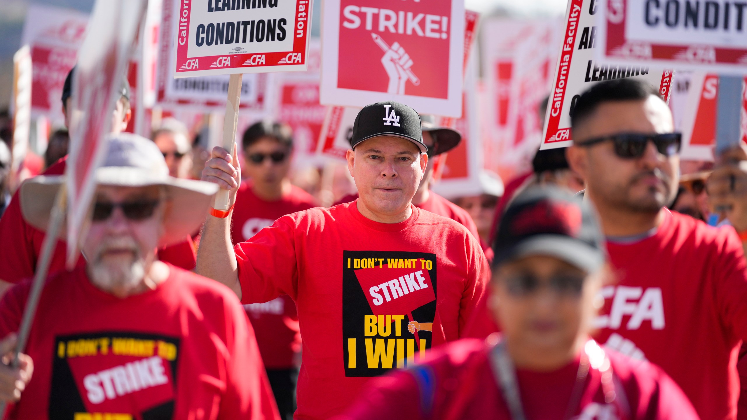 Members of the California Faculty Association rally and picket during a strike at California State Polytechnic University, Pomona, on Monday, Dec. 4, 2023, in Pomona, Calif. (AP Photo/Ashley Landis)