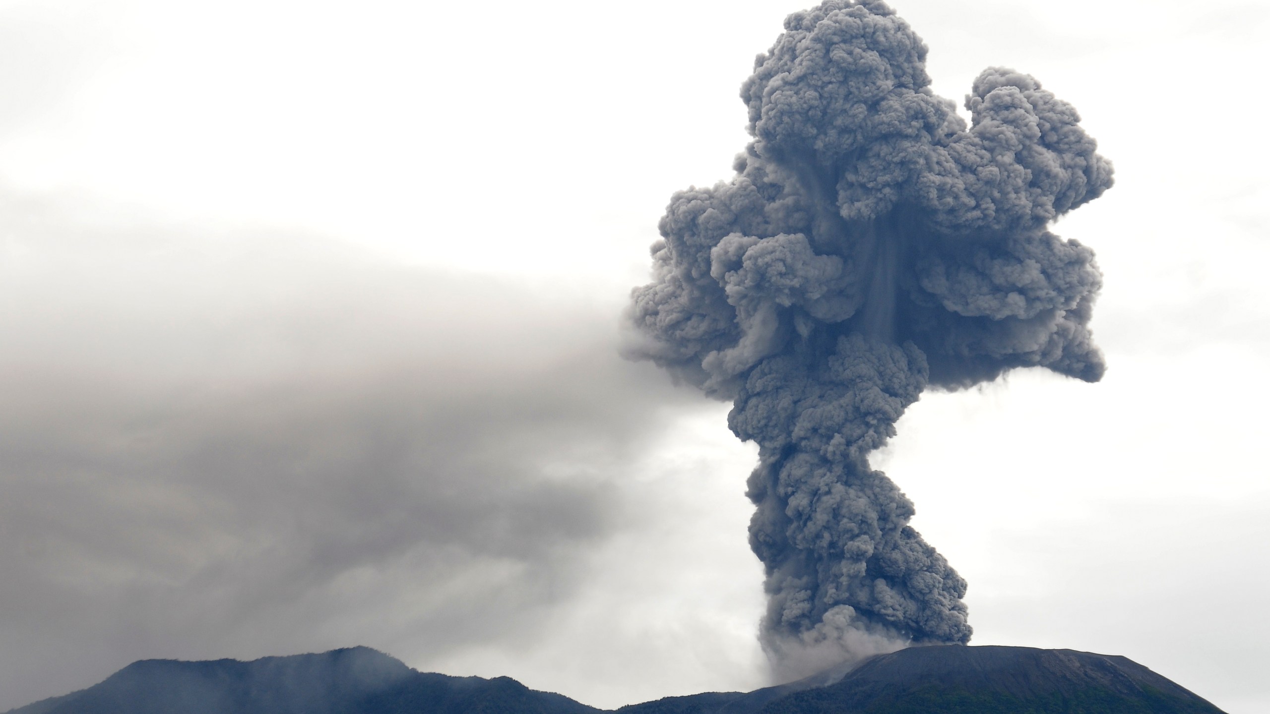 Mount Marapi spews volcanic materials during its eruption in Agam, West Sumatra, Indonesia, Monday, Dec. 4, 2023. The volcano spewed thick columns of ash as high as 3,000 meters (9,800 feet) into the sky in a sudden eruption Sunday and hot ash clouds spread several miles (kilometers). (AP Photo/Ardhy Fernando)