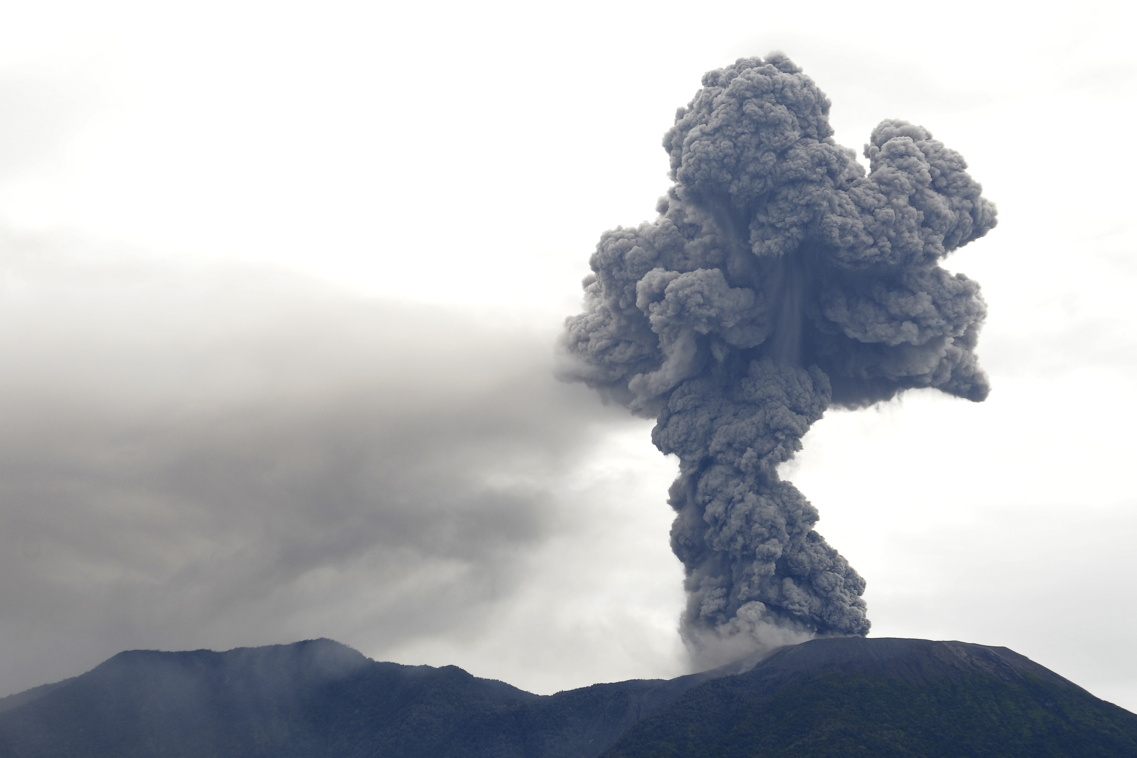 Mount Marapi spews volcanic materials during its eruption in Agam, West Sumatra, Indonesia, Monday, Dec. 4, 2023. The volcano spewed thick columns of ash as high as 3,000 meters (9,800 feet) into the sky in a sudden eruption Sunday and hot ash clouds spread several miles (kilometers). (AP Photo/Ardhy Fernando)