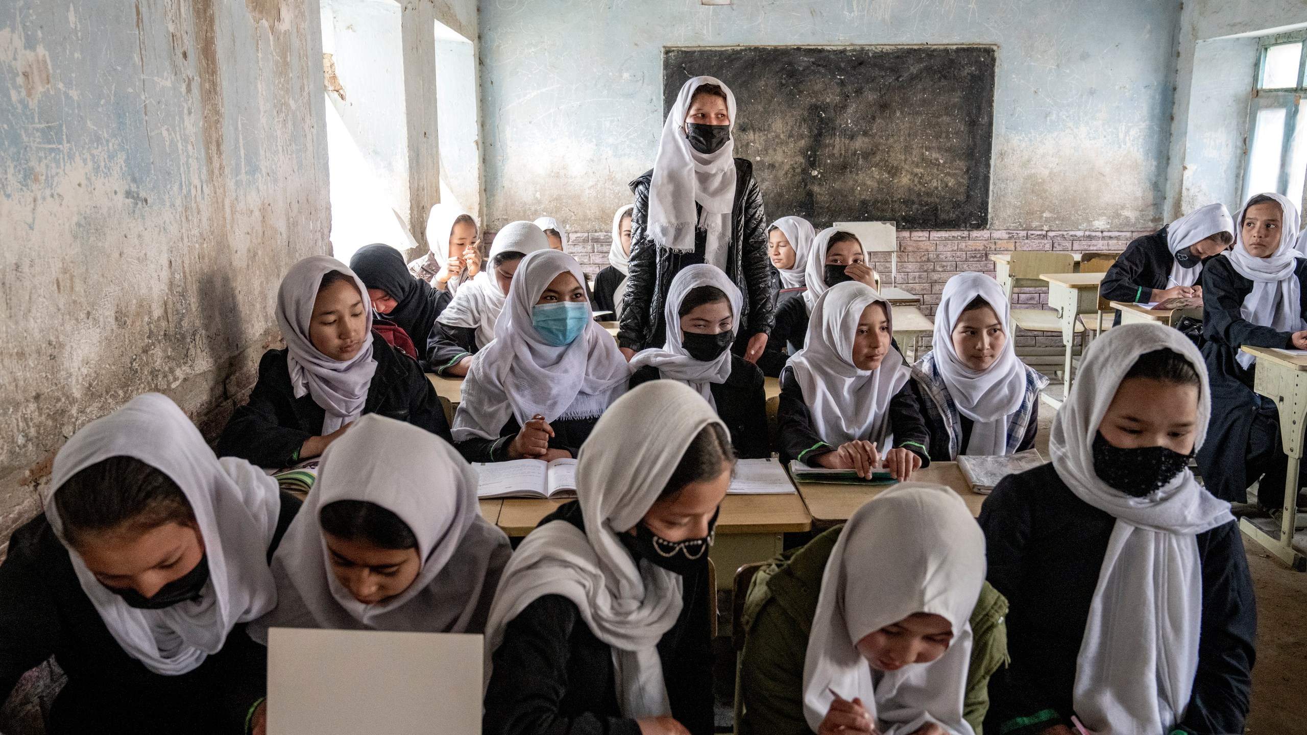 FILE - Afghan school girls attend their classroom on the first day of the new school year, in Kabul, Saturday, March 25, 2023. The Taliban's "abusive" educational policies are harming boys as well as girls in Afghanistan, according to a Human Rights Watch report published Wednesday. (AP Photo/Ebrahim Noroozi, File)