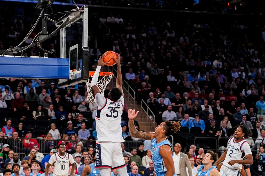 UConn forward Samson Johnson (35) dunks the ball during the first half of an NCAA college basketball game against North Carolina in New York, Tuesday, Dec. 5, 2023. (AP Photo/Peter K. Afriyie)