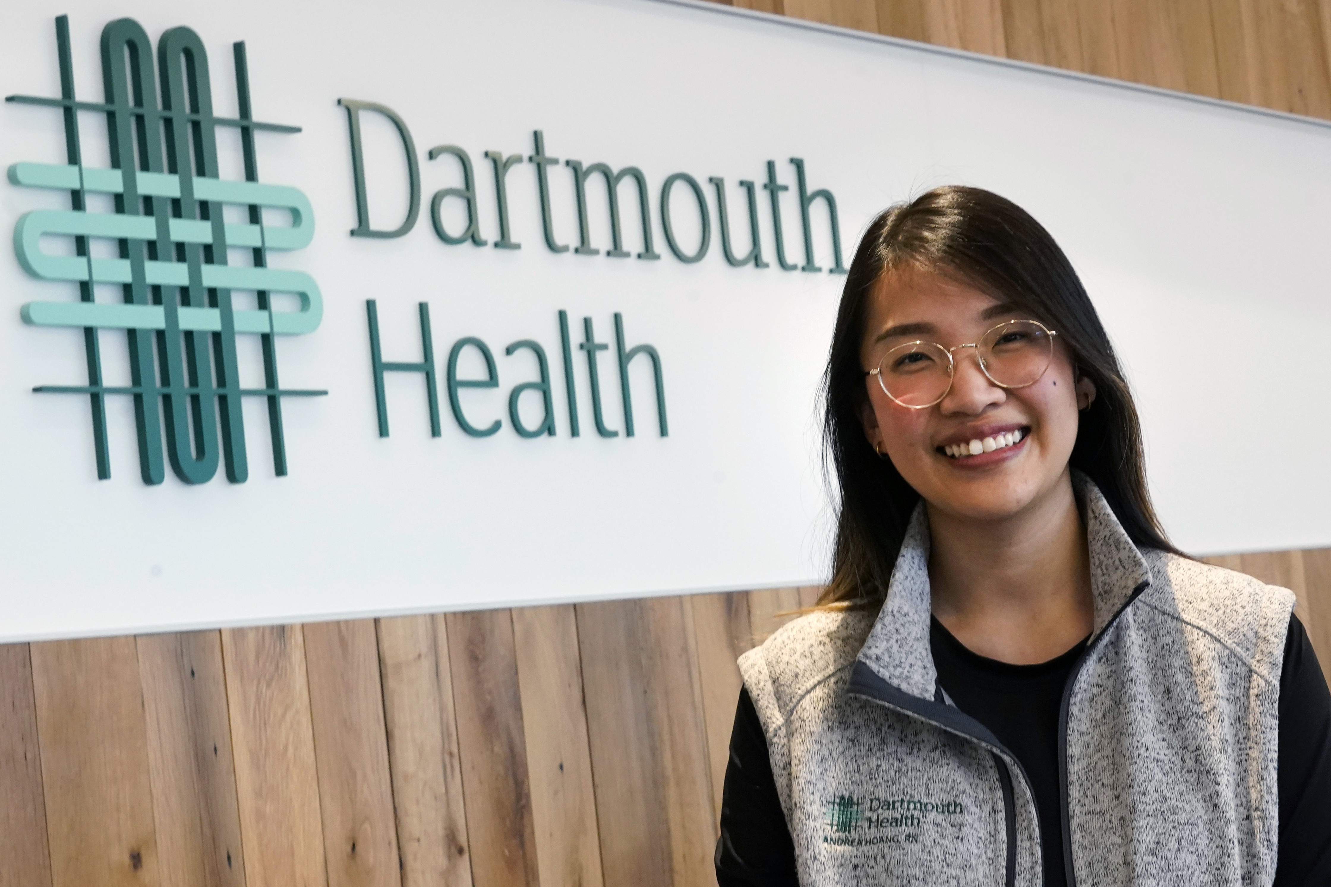 Andy Hoang, a recent nursing graduate, poses at the Dartmouth-Hitchcock Medical Center, Tuesday, Dec. 5, 2023, in Lebanon, N.H. Hoang, 23, started to feel dizzy and nauseous during a cardiac training session at the hospital and needed help immediately. Instead of practicing chest compressions on a mannequin in the simulated environment of their training, her four colleagues sprung into action and went to work on her. (AP Photo/Charles Krupa)