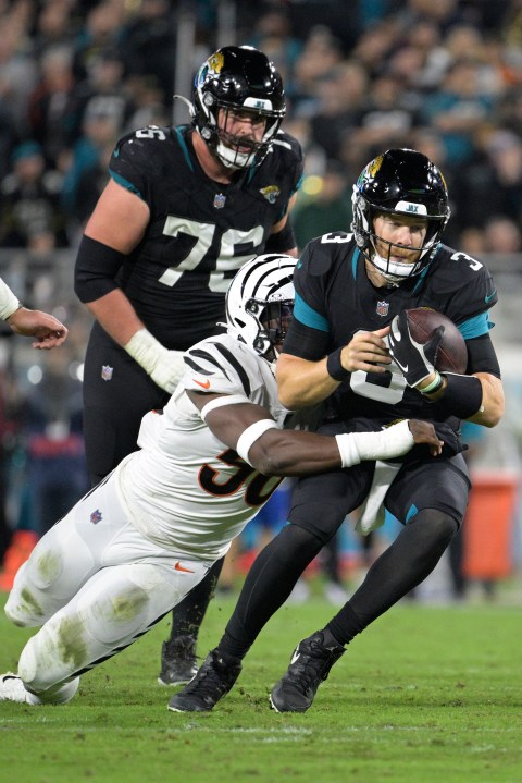 Jacksonville Jaguars quarterback C.J. Beathard (3) is tackled by Cincinnati Bengals defensive end Joseph Ossai (58) during the second half of an NFL football game, Monday, Dec. 4, 2023, in Jacksonville, Fla. (AP Photo/Phelan M. Ebenhack)