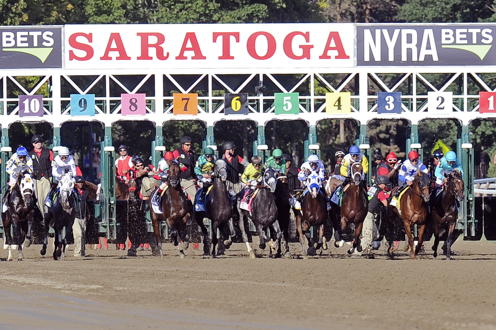 FILE - Horses break from the gate at the start of the Travers Stakes horse race at Saratoga Race Course in Saratoga Springs, Aug. 27, 2016. The 2024 Belmont Stakes will be run at Saratoga Race Course, with the third leg of horse racing's Triple Crown shifting from Long Island to upstate to New York because of the massive renovation of Belmont Park. New York Gov. Kathy Hochul announced the move Wednesday, Dec. 6, 2023, which has been expected for some time since the New York Racing Association unveiled plans for the $455 million Belmont Park project. (AP Photo/Hans Pennink, File)