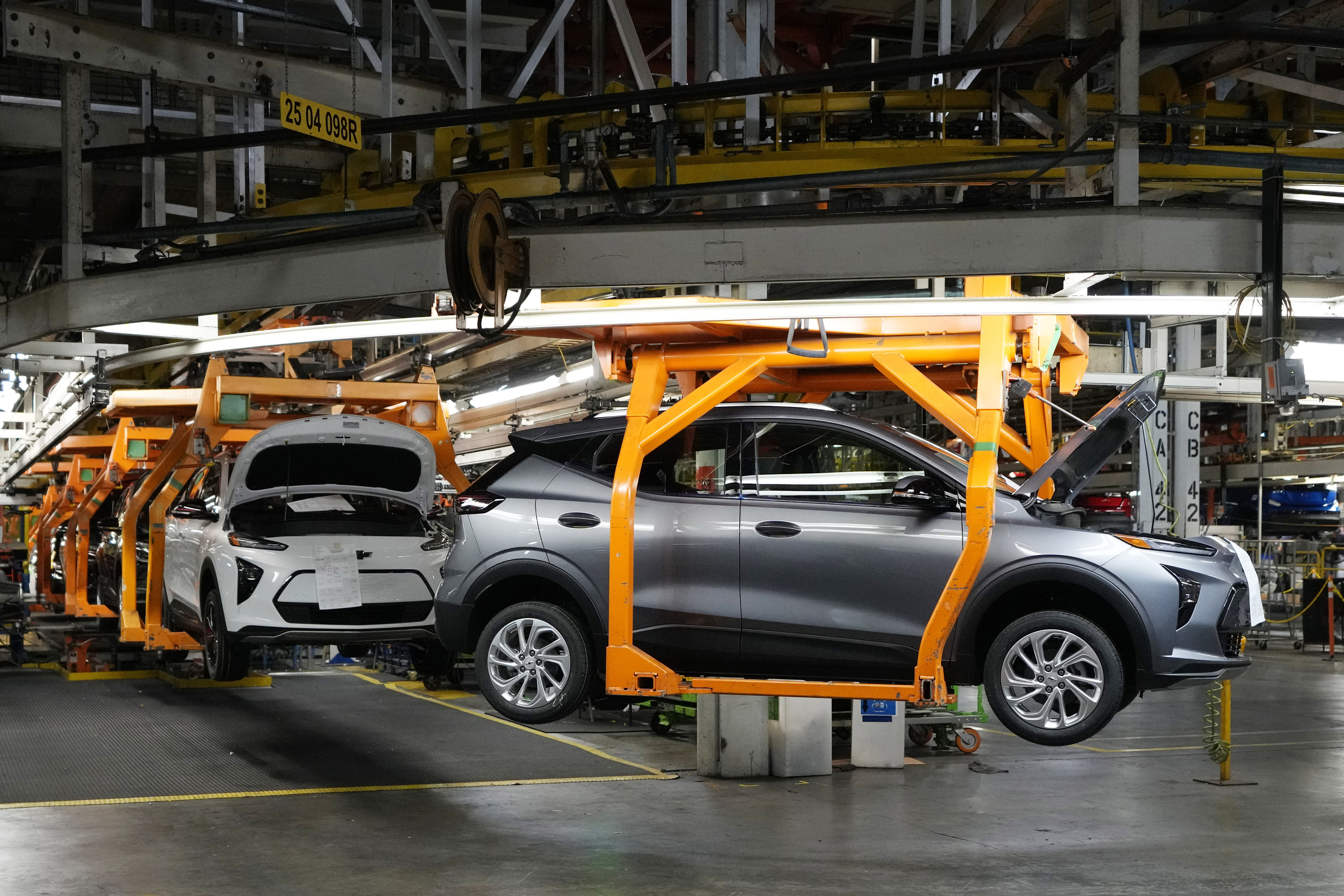 File - Vehicles move along the 2023 Chevrolet Bolt EV and EUV assembly line at the General Motors Orion Assembly June 15, 2023, in Lake Orion, Mich. Despite new electric vehicle sales hitting a record in the US this year, sales growth is starting to slow and fall short of the auto industry's lofty ambitions to transition away from combustion engines.(AP Photo/Carlos Osorio, File)